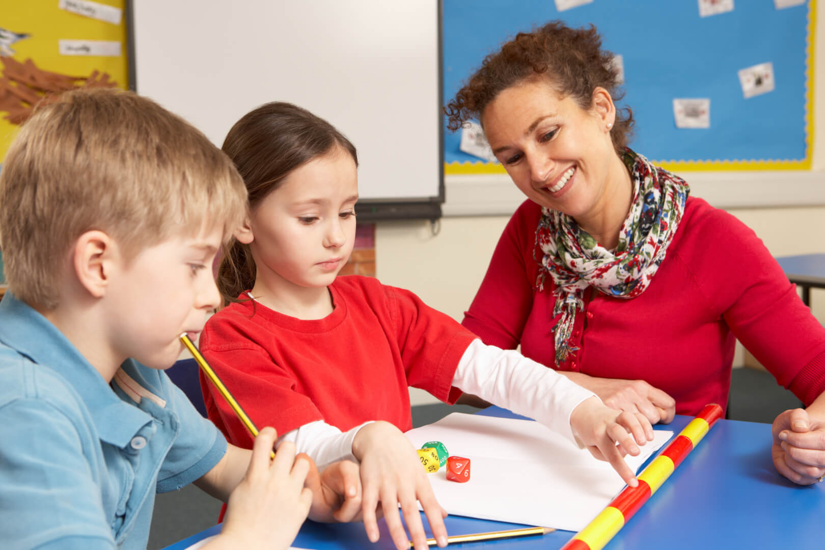 Teacher with two primary school students